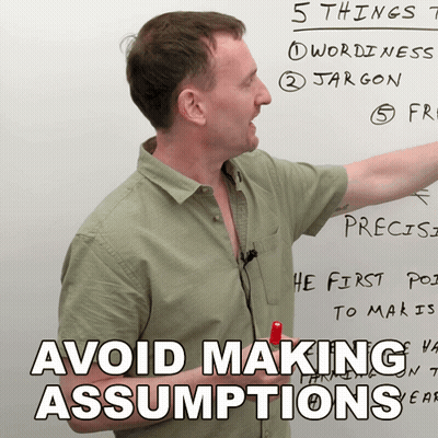 Man Pointing At Whiteboard Saying Avoid Making Assumptions GIF