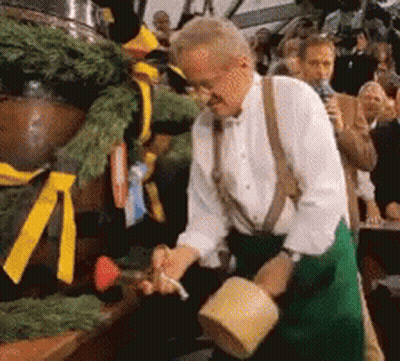 Man Pouring Beer Into Barrel While Crowd Watches GIF