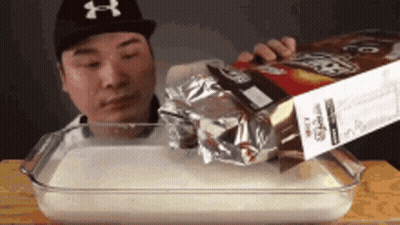 Man Pouring Cereal Into Glass Dish GIF