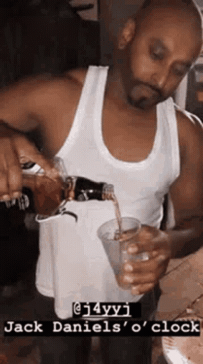 Man Pouring Drink From Bottle Into Cup GIF