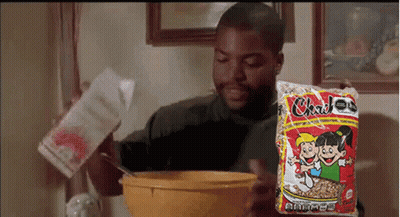 Man Pouring Milk Into Cereal Bowl Holding Bag GIF