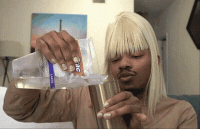 Man Pouring Water From Large Bottle Into Cup GIF
