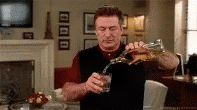 Man Pouring Whiskey From Bottle Into Glass GIF