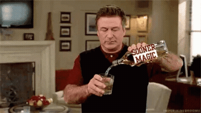 Man Pouring Whiskey Glass In Living Room GIF