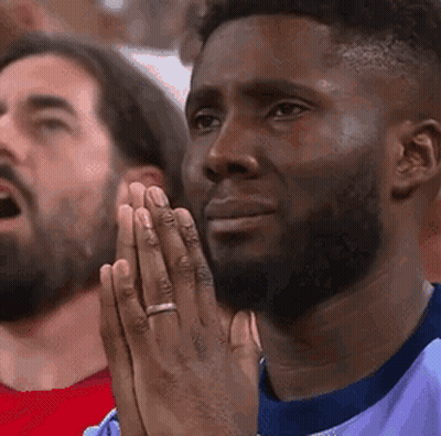 Man Praying While Watching Game GIF