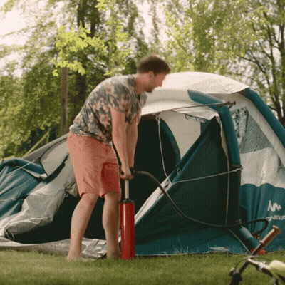 Man Pumping Tent With Red Pump GIF