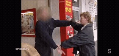 Man Punched In Face By Woman In Front Of Vending Machine GIF