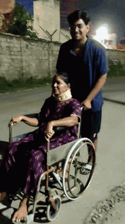 Man Pushes Woman In Wheelchair Down Street GIF