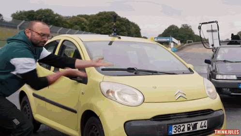 Man Pushes Yellow Car With License Plate 382.BWT 44 GIF