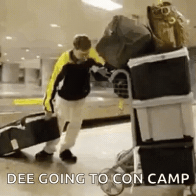 Man Pushing Cart Full of Luggage