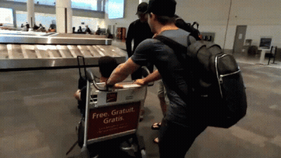 Man Pushing Cart Saying Free Gratuit Gratis GIF