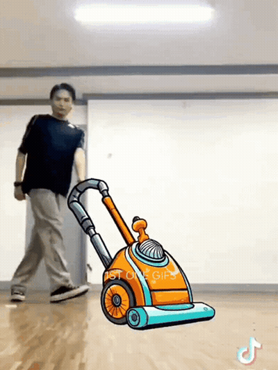 Man Pushing Cartoon Vacuum Cleaner In Dance Studio GIF