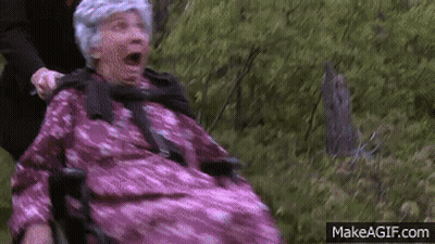 Man Pushing Elderly Woman In Pink Dress In Wheelchair GIF