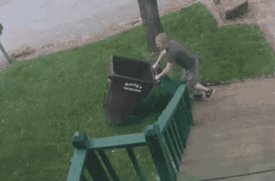 Man Pushing Garbage Can Saying Bank GIF