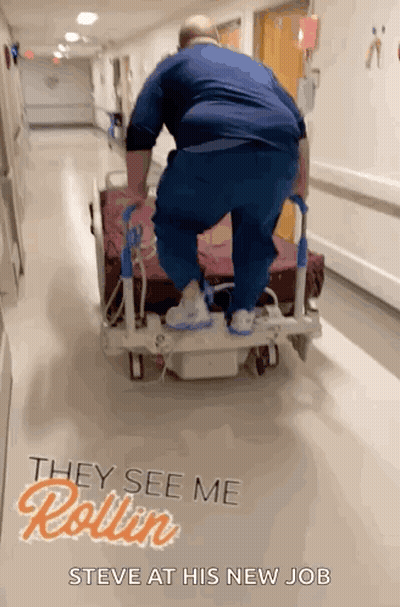 Man Pushing Hospital Bed With They See Me Rollin Steve GIF