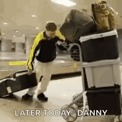 Man Pushing Luggage Cart With Suitcase