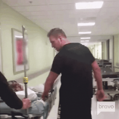 Man Pushing Patient On Stretcher In Hospital Hallway Bravo GIF