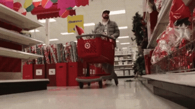 Man Pushing Shopping Cart In Clearance Store GIF