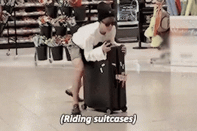 Man Pushing Suitcase Saying Riding Suitcases GIF