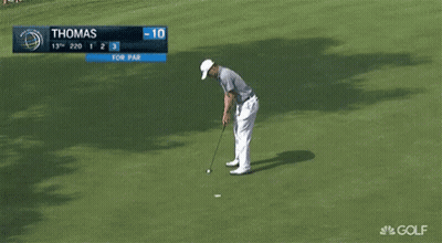 Man Putting Golf Ball on Green