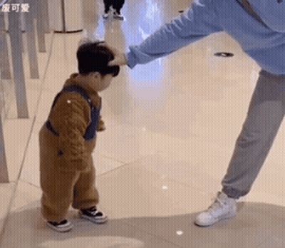 Man Putting Hand On Little Boy's Head GIF