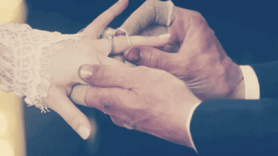 Man Putting Ring On Woman's Finger GIF
