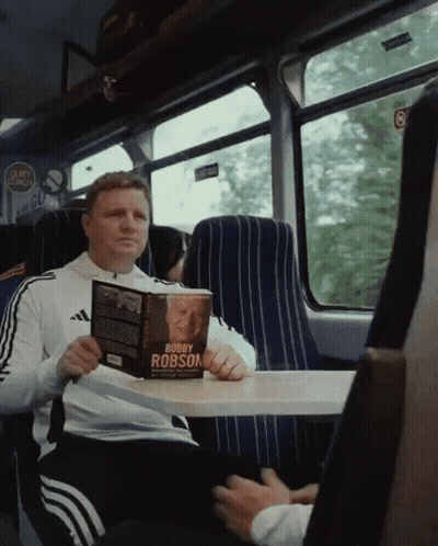 Man Reading Bobby Robson Book GIF