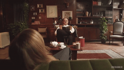 Man Reading Book, Woman In Front GIF