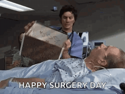 Man Reading In Hospital Bed, Doctor Holding Box GIF
