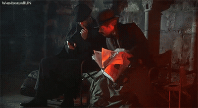 Man Reading Newspaper And Man On Phone GIF