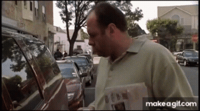 Man Reading Newspaper In Front Of Car GIF