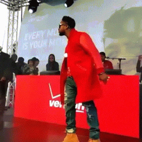 Man Red Coat Dancing By Red Verizon Sign GIF