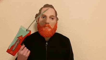 Man Releasing Monopoly Money Through Gun GIF