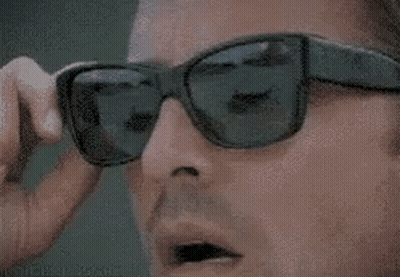 Man Removing Sunglasses And Looking GIF
