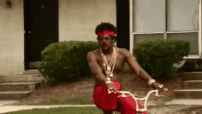 Man Riding Bike In Front Of House GIF