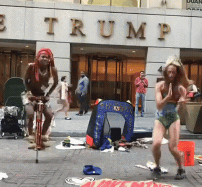 Man Riding Bike In Front Of Trump Building GIF