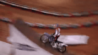 Man Riding Bike In Front Of Zamx Sign GIF