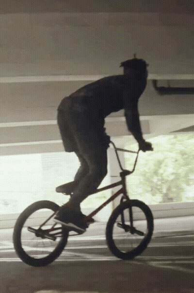 Man Riding Bike In Parking Garage GIF