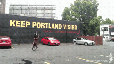 Man Riding Bike Keep Portland Weird Sign GIF