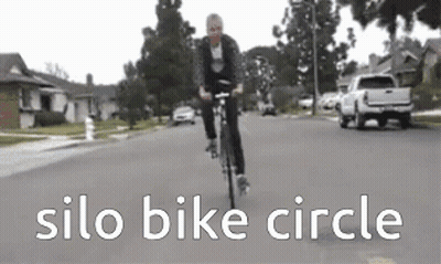 Man Riding Bike Under Silo Bike Circle GIF