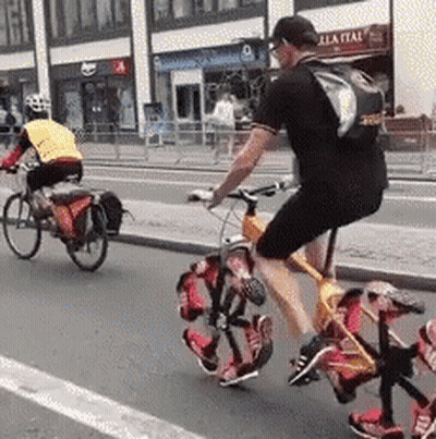 Man Riding Bike With Backpack GIF