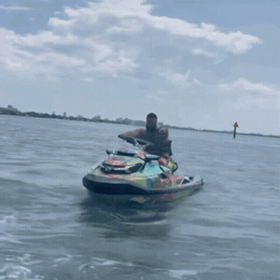 Man Riding Colorful Jet Ski In Water GIF