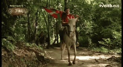 Man Riding Donkey Holding Eitb.eus Flag GIF