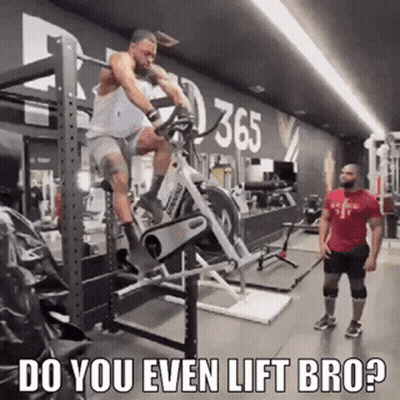 Man Riding Exercise Bike In Gym While Man Watches GIF