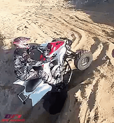 Man Riding Four Wheeler in Sand