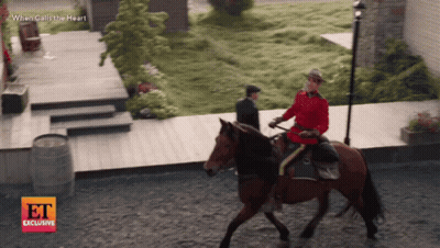Man Riding Horse In Front Of When Calls The Heart Sign GIF