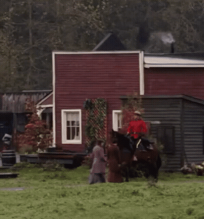 Man Riding Horse In Town GIF