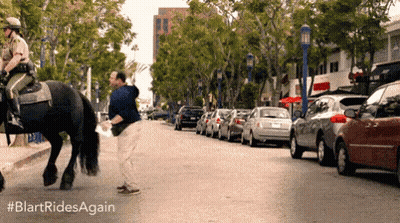 Man Riding Horse On City Street GIF