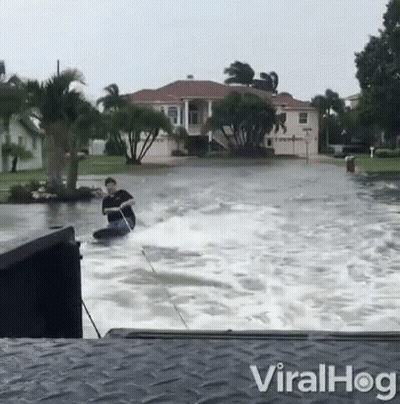 Man Riding Jet Ski In Flood GIF