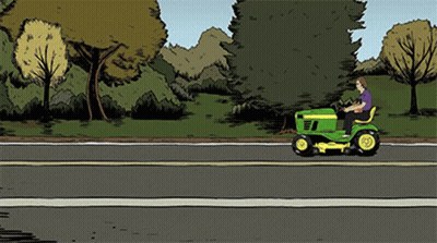 Man Riding Lawn Mower Down Road